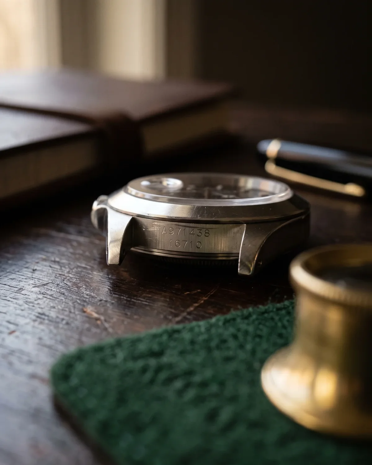 A single desk with a loupe, a notebook, and one watch on a tray: the whole operation in one frame.