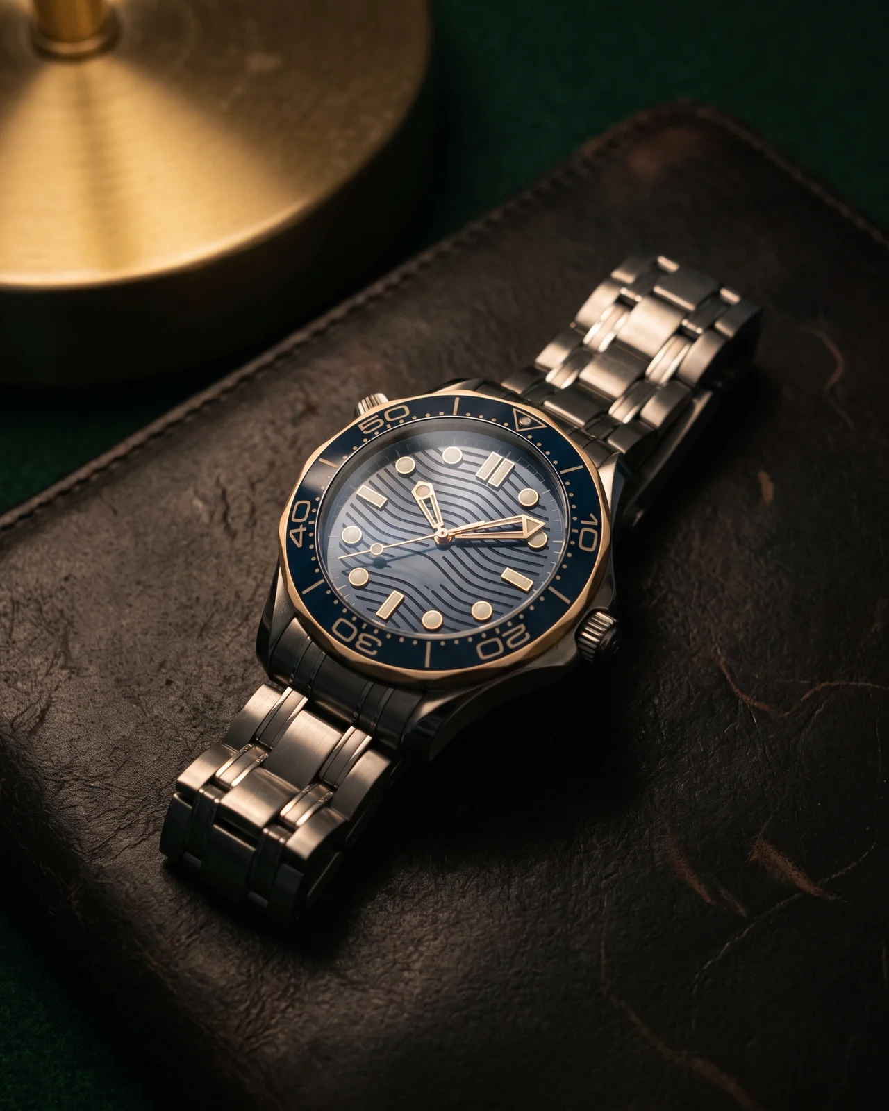 A blue wave-dial Diver 300M on dark leather, the scalloped bezel and the helium valve crown catching the light.